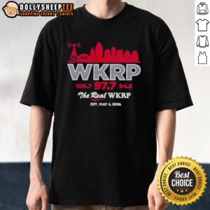 Alt Text: Official The Real Wkrp Inaugural 2026 Skyline T-Shirt featuring a vibrant skyline design and bold text.
