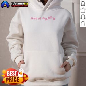Adwoa Aboah in a pink 'Out Of Order' hoodie, showcasing a trendy street style look.