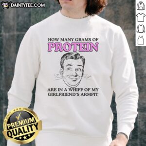 Close-up of a sweatshirt with humorous text about protein in girlfriend's armpit sweat, highlighting quirky fashion.