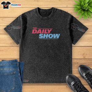 Nice The Daily Show washed t-shirt displayed on a wooden background, featuring a vibrant graphic print and casual style.