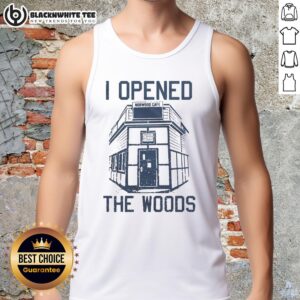 Model wearing the Top I Opened The Woods tank top in a lush forest setting, showcasing a stylish outdoor look.