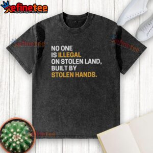Alt Text: Sarcastic 'No One Is Illegal On Stolen Land' graphic on a washed t-shirt, highlighting social justice themes.