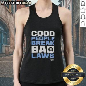 Topher Field wearing a tank top with 'Awesome Good People Break Bad Laws' slogan, promoting free speech and activism.