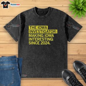 Good The Iowa Investigator washed t-shirt, promoting Iowa's interesting stories since 2024, featuring bold graphic design.