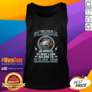Original Philadelphia Eagles NFL tank top featuring 'I May Live in Florida, But My Heart Belongs to Eagles' design.
