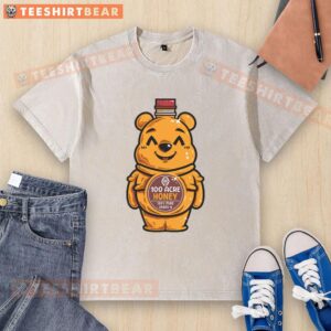 Cute bear design on a honey bottle graphic printed on a washed t-shirt, perfect for casual wear.