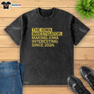 Alt Text: Premium washed t-shirt featuring The Iowa Investigator - Making Iowa Interesting Since 2024 design.