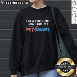 Alt Text: Person wearing a Premium I'm A F*cking Idiot sweatshirt from PetSmart while smiling in a cozy setting.