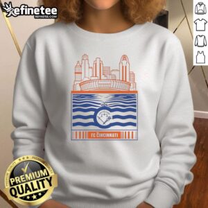Alt Text: Retro sweatshirt featuring the FC Cincinnati logo with a city skyline and river view in the background.