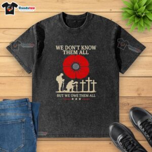 Premium We Don't Know Them All But We Owe Them All retro washed t-shirt displayed on a wooden background.