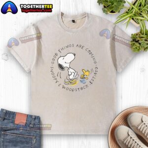 Alt Text: Snoopy and Woodstock graphic on a washed t-shirt, featuring 'Good Things Are Coming' with peanuts theme.
