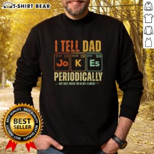 Man wearing a 'Good I Tell Dad Jokes Periodically' retro sweatshirt in a cozy, casual setting, showcasing humor and style.