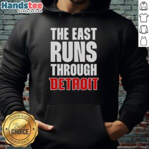 Stylish Hot The East Runs Through Detroit hoodie in urban setting, showcasing Detroit pride and streetwear fashion.