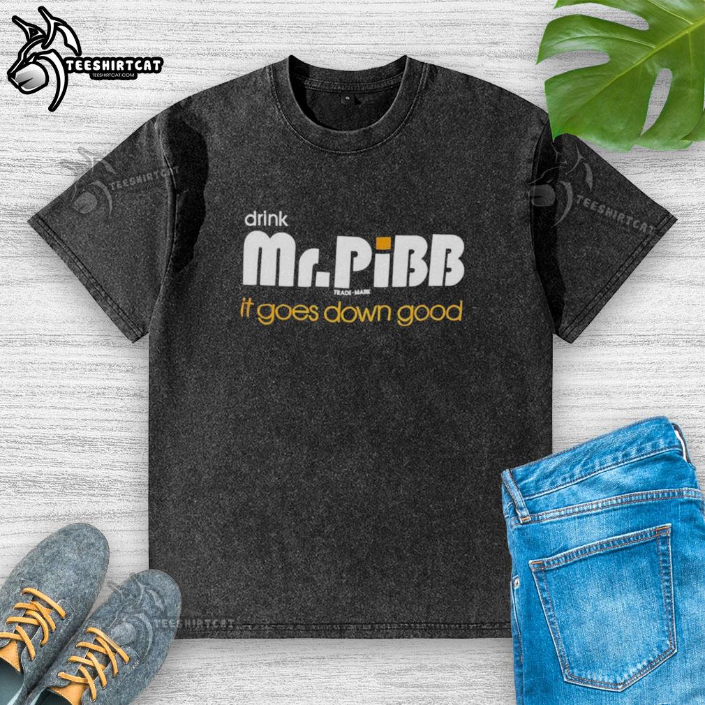 hot-mr-pibb-drink-it-goes-down-good-washed-t-shirt Alt Text: Refreshing Hot Mr. Pibb drink in a glass with ice, next to a stylish washed T-shirt, perfect for a casual day.
