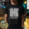 Hot USA The World Is Watching Colbert Kimmel Meyers T-Shirt design featuring bold graphics and vibrant colors.