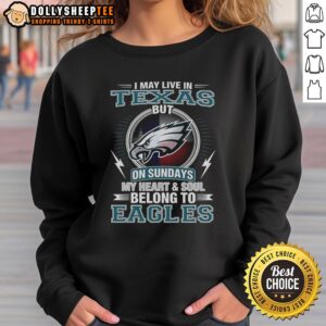 Official Philadelphia Eagles sweatshirt with 'I May Live In Texas, But My Heart Belongs To Eagles' design.