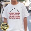 Person wearing a 'Nude Project Seven Stars' T-shirt, smiling on the way to work, inspired by TikTok dance trends.