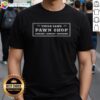 Official Uncle Sam's Pawn Shop T-shirt featuring luggage, jewelry, and shotguns design, perfect for fans of unique apparel.