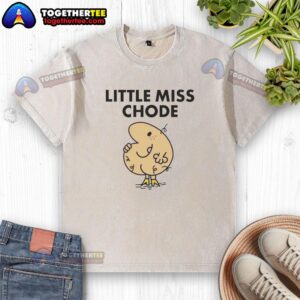 Trendy Hot Little Miss Chode washed t-shirt displayed on a wooden background, showcasing its stylish design and comfortable fit.