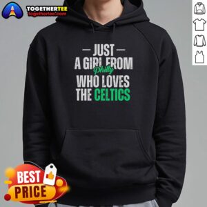 Girl from Philly wearing a Boston Celtics hoodie, showcasing her love for the team in a vibrant urban setting.