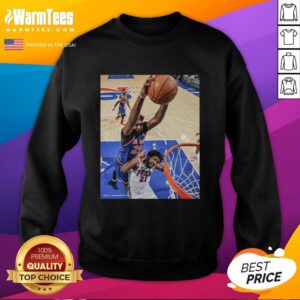 Hot Joel Embiid wearing a Philadelphia 76ers sweatshirt, showcasing team spirit and style on game day.