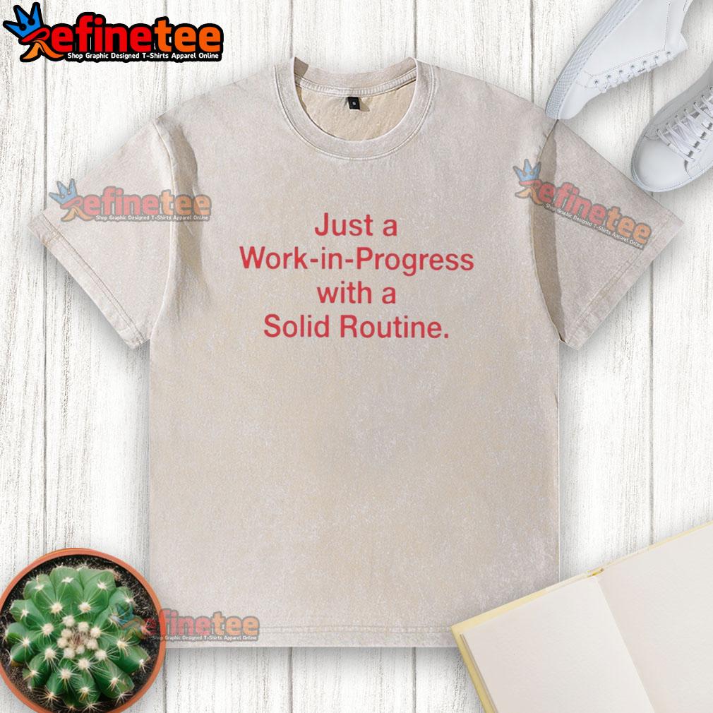 pretty-just-a-work-in-progress-with-a-solid-routine-washed-t-shirt Alt Text: 'Pretty Just A Work In Progress With A Solid Routine washed t-shirt displayed on a hanger, showcasing its casual style.'