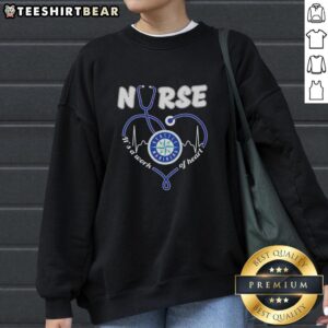 Alt Text: Original Seattle Mariners Nurse sweatshirt featuring 'It's a Work of Heart' design in vibrant colors.
