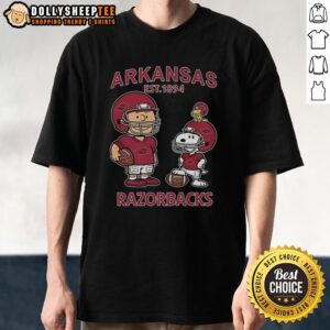 Nice Charlie Brown and Snoopy X Arkansas Razorbacks NCAA Football Est 1894 T-Shirt featuring vibrant graphics and team spirit.
