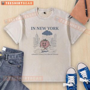 Pretty tomato walking in the rain in New York's concrete jungle, showcasing the Wet Dream tomato washed t-shirt.