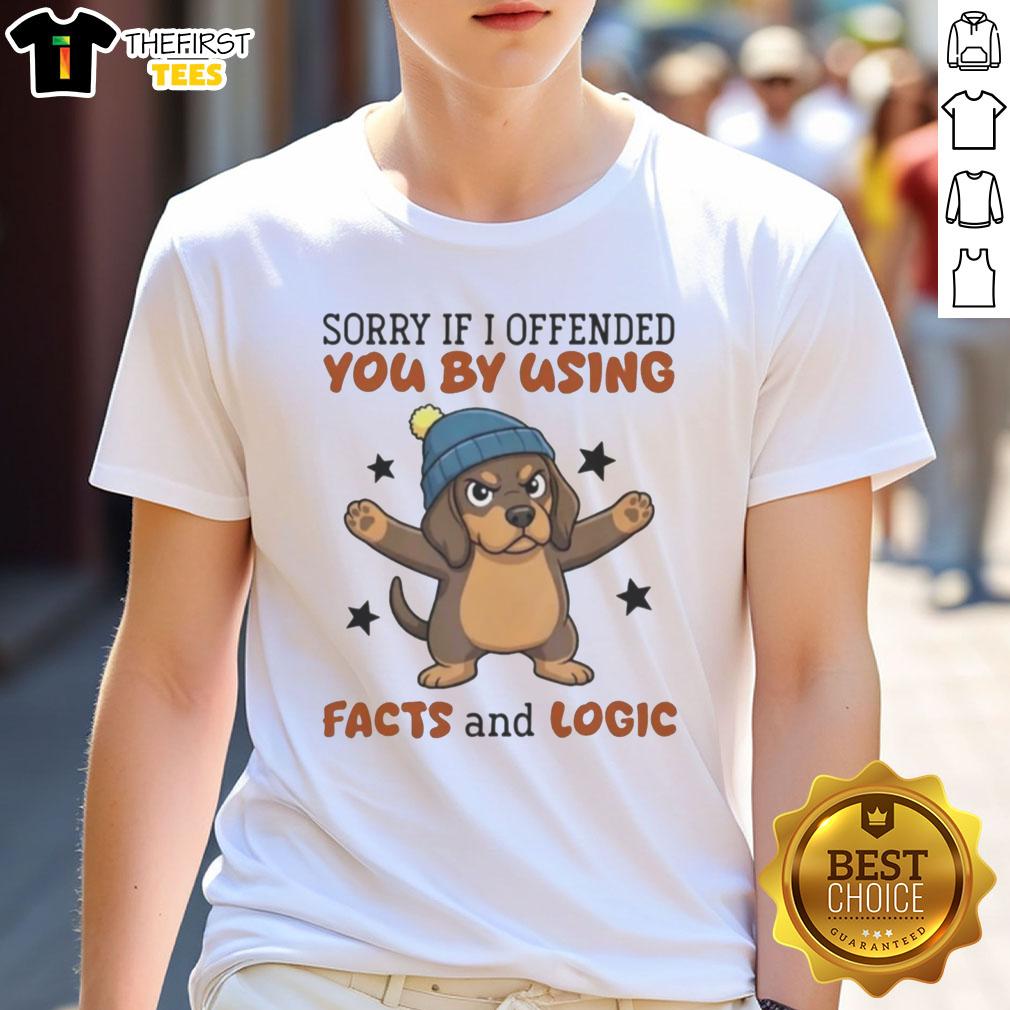 top-sorry-if-i-offended-you-by-using-facts-and-logic-grumpy-dachshund-in-beanie-t-shirt Grumpy Dachshund in a beanie wearing a T-shirt saying Sorry If I Offended You By Using Facts And Logic.