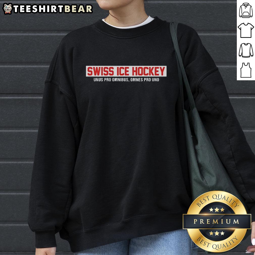 top-swiss-ice-hockey-unus-pro-omnibus-omnes-pro-uno-red-text-sweatshirt Alt Text: Top Swiss Ice Hockey sweatshirt featuring 'Unus Pro Omnibus, Omnes Pro Uno' in bold red text on a stylish design.