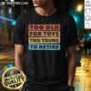 Alt Text: Funny 'Too Old For Toys Too Young To Retire' T-Shirt design for adults, perfect for playful gift ideas.