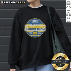 Alt Text: Michigan Wolverines 2026 Big Ten Women's Tennis Tournament champions sweatshirt in team locker room setting.