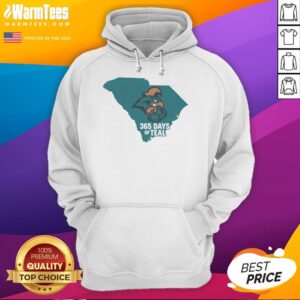 Coastal Carolina 365 Days of Teal hoodie displayed against a beach backdrop, showcasing vibrant teal color and logo.