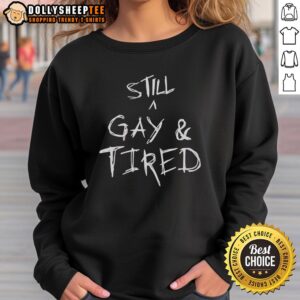 Alt Text: Handwritten text on a sweatshirt reading Still A Gay And Tired for a pride statement, showcasing LGBTQ+ pride.