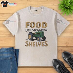 Vintage washed t-shirt featuring a nice tractor design with 'Food Doesn't Grow on Shelves' slogan in rustic style.