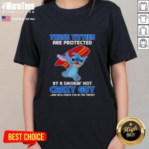 Alt Text: Ladies tee featuring 'These Titties Are Protected By A Smokin' Hot Crazy Guy' graphic design, perfect for bold fashion.