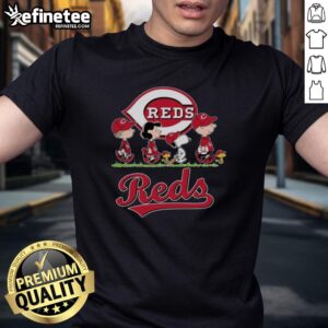 Alt Text: Snoopy, Charlie Brown, Linus, and Lucy wearing Cincinnati Reds baseball jersey T-shirts, celebrating team spirit.