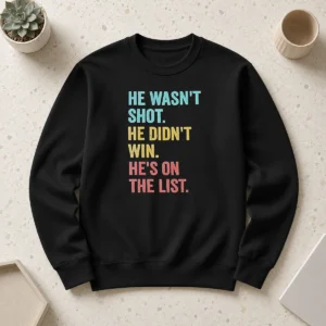 Awesome He Wasn'T Shot He Didn'T Win He'S On The List sweater in dark gray with bold white lettering, displayed front view