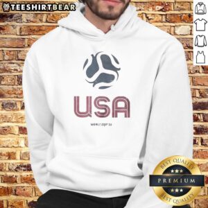 Alt Text: Pretty United States Home Advantage Soccer Ball World Cup 26 hoodie displayed on a wooden background.