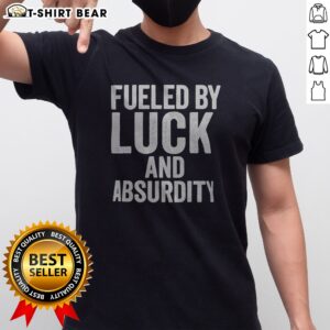Awesome Fueled By Luck And Absurdity Retro Distressed Typography Inspiration Shirt displayed on a flat lay