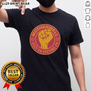Official Motherwell FC Keep On Keeping On Raised Fist T-Shirt featuring bold graphics and club colors for fans.