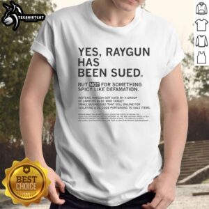 Good Raygun Has Been Sued But Not For Something Spicy Like Defamation Shirt displayed on a flat lay background