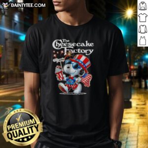 Pretty Snoopy X The Cheesecake Factory Fourth Of July American 250 Years 1776 2026 Fireworks Shirt displayed on a flat lay