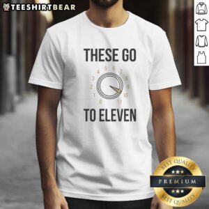 Official These Go To Eleven Shirt displayed on a neutral background, showcasing its vibrant design.