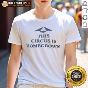 Good This Circus Is Homegrown Shirt displayed on a wooden surface with vibrant colors and graphic design.