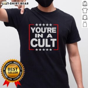 Alt Text: Top You're In A Cult satirical political statement T-shirt featuring bold text and a stylish design for casual wear.