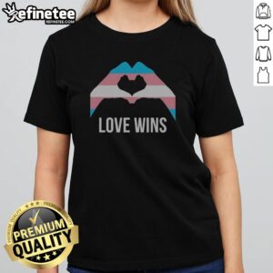 Funny Love Wins Transgender Pride Flag Heart Hands Symbol Equality LGBTQIA Plus girlt shirt displayed on a flat surface.