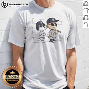 Top Snoopy And Charlie Brown Baseball Wearing New York Yankees Jersey Shirt displayed on a hanger