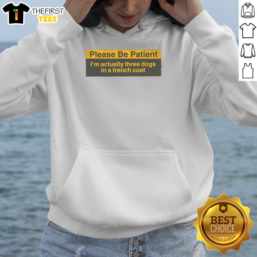 funny-please-be-patient-im-actually-three-dogs-in-a-trench-coat-hoodie Funny hoodie featuring three dogs in a trench coat, humorously promoting patience with a playful design.
